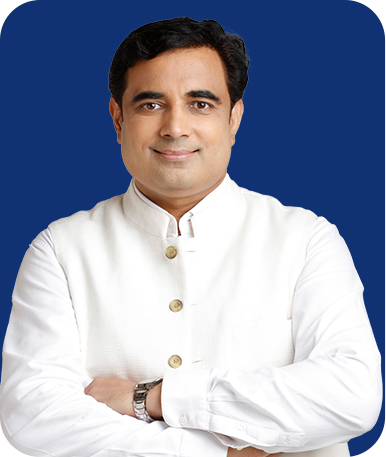 image of celebrity astrologer in India pt. Pawan Kaushik wearing a smile with white suite and the background is blue